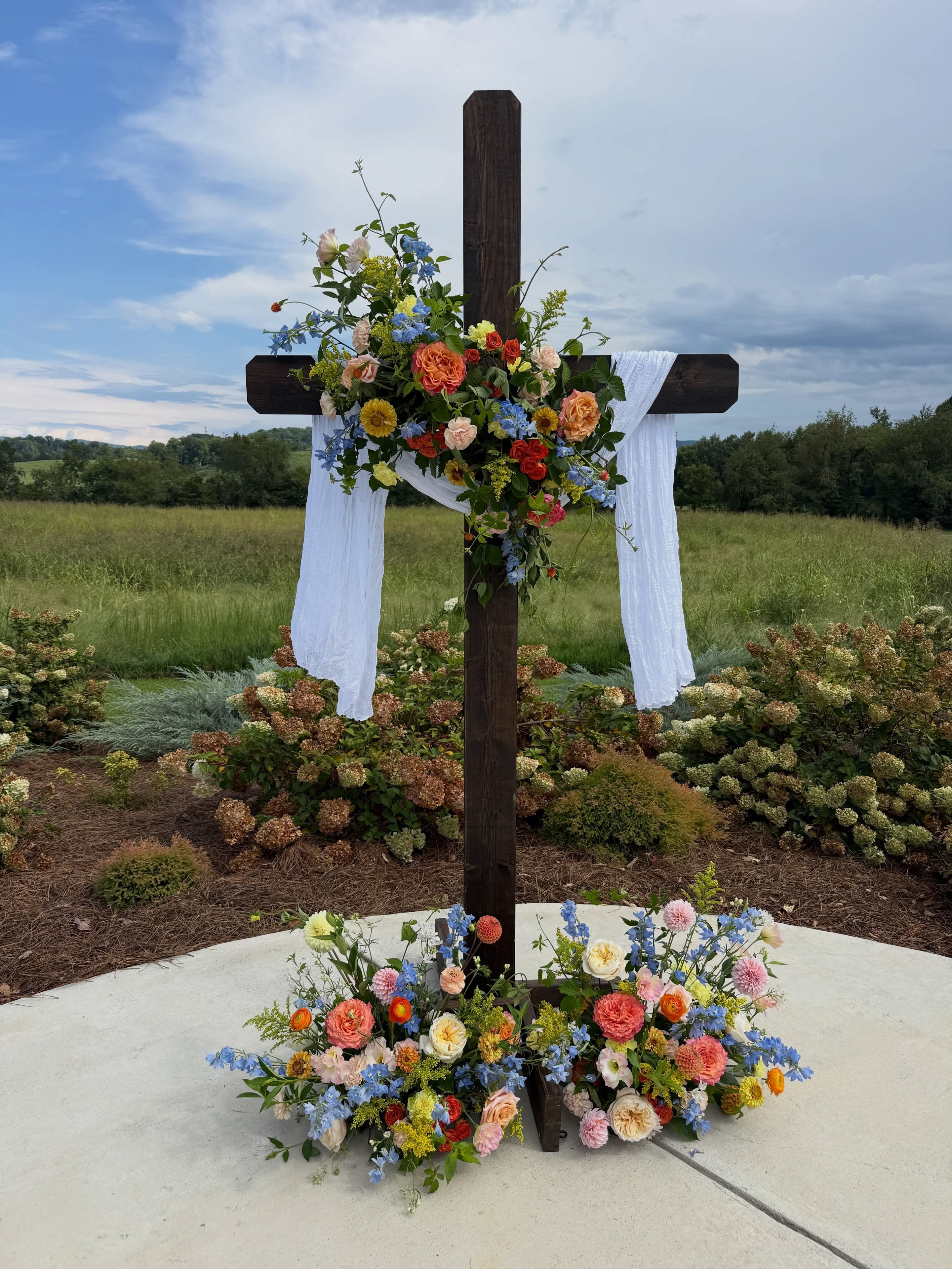 Decorated wooden cross with colorful floral arrangements